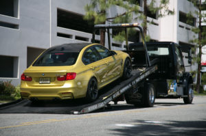 Towing a BMW M3 on a FlatbedTow Truck